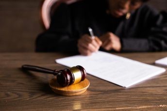 Photo by KATRIN BOLOVTSOVA: https://www.pexels.com/photo/judge-signing-on-the-papers-6077447/