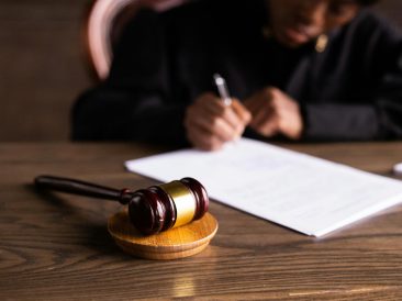 Photo by KATRIN BOLOVTSOVA: https://www.pexels.com/photo/judge-signing-on-the-papers-6077447/