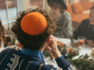 Photo by Yaroslav Shuraev: https://www.pexels.com/photo/back-view-of-a-man-sitting-at-the-dinner-table-wearing-a-skullcap-6184501/