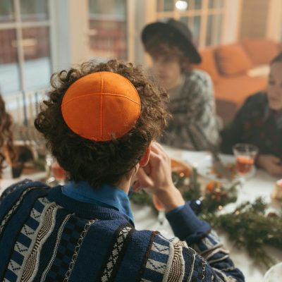 Photo by Yaroslav Shuraev: https://www.pexels.com/photo/back-view-of-a-man-sitting-at-the-dinner-table-wearing-a-skullcap-6184501/