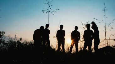Photo by Afta Putta Gunawan: https://www.pexels.com/photo/silhouette-group-of-people-standing-on-grass-field-1250346/